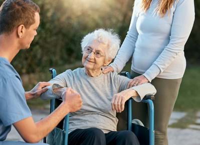 Volunteers visiting and giving company to elderly lady