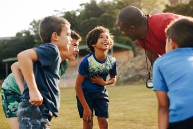 volunteer teaching sport to local kids