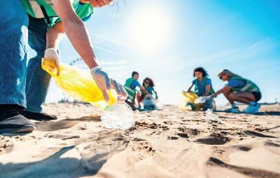 volunteers picking up rubbish from the beach